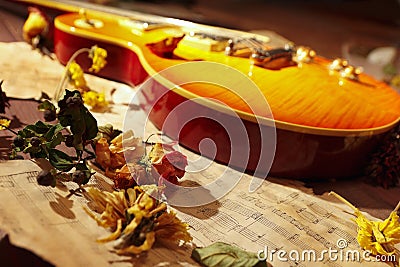 Vintage electric jazz guitar, dried flowers and old notes Stock Photo