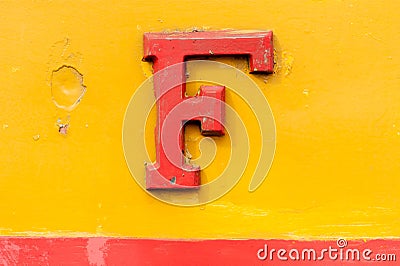 Vintage embossed metal red F over yellow Stock Photo