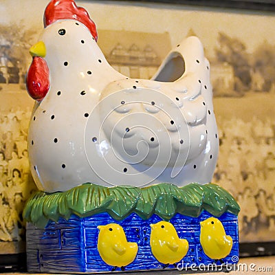 Chicken, Rooster Statue with Three Baby Chicks Stock Photo