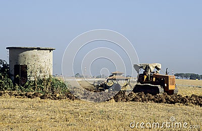 Vintage Farm Tractor ploughing agricultural field Editorial Stock Photo
