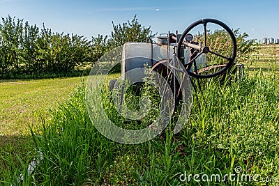 Vintage farming pull-type sprayer in tall grass Stock Photo