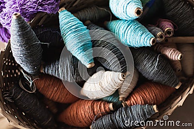 Filling carriers of the loom with spool of threads inside Stock Photo