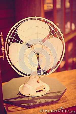 Vintage filter: Vintage fan on wood table in old shop Stock Photo