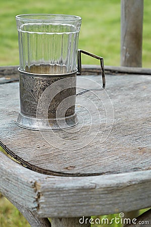 Vintage glass on an old chair Stock Photo