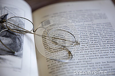 Vintage glasses resting on an old book Editorial Stock Photo