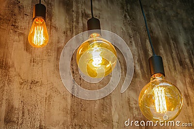 Vintage glowing light bulbs. Three hanging retro incandescent lamps Stock Photo