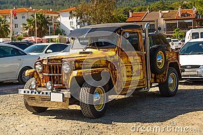 Vintage gold colored Jeep car outside the roadman in the parking lot Editorial Stock Photo