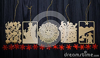 Vintage gold flat Christmas tree toys with red stars on wooden background Stock Photo