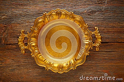 Vintage golden tray round on aged brown wood Stock Photo