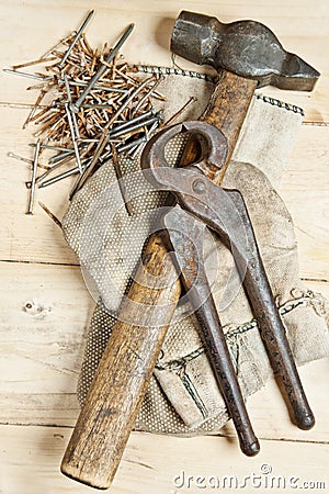 Vintage hammer with nails on wood background Stock Photo