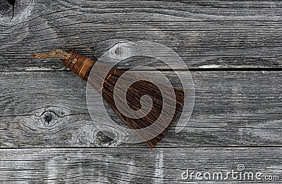 Vintage hand broom on aged wooden plank floor Stock Photo