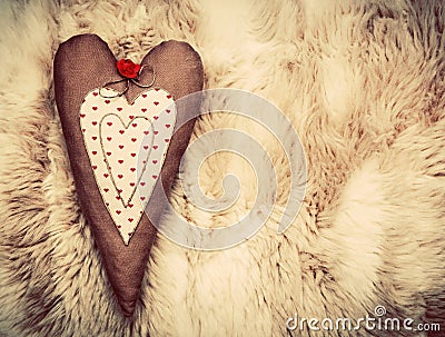 Vintage handmade plush heart pillow on soft blanket Stock Photo