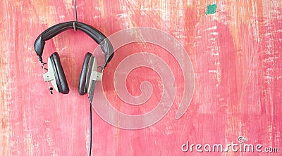 Vintage headphones hanging on grungy wall, listening,podcast, mu Stock Photo
