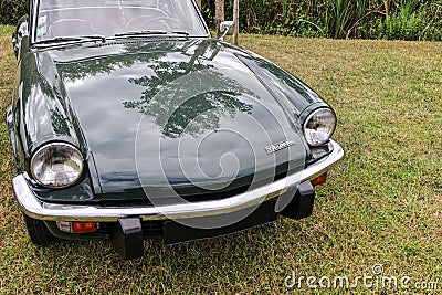 Vintage historic Triumph convertible car parked on a grassy meadow Editorial Stock Photo
