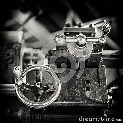 Vintage image of the adjustment knobs of an antique parallel lathe for turning mechanical parts, black and white, tool carriage Stock Photo