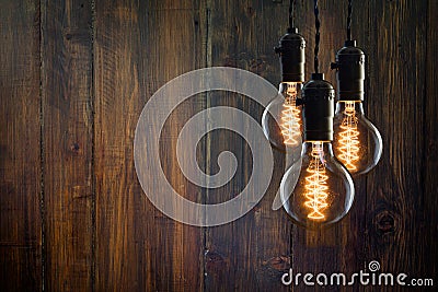 Vintage incandescent Edison type bulbs on wooden background Stock Photo