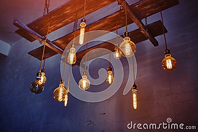 Vintage incandescent lamps mounted on a wooden ceiling structure. Christmas festive decoration Stock Photo