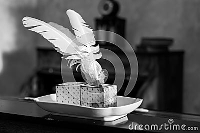 Vintage inkwell with feather pen Stock Photo
