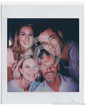 Vintage Instant Film Print Of Senior Parents And Adult Offspring Posing For Selfie Stock Photo