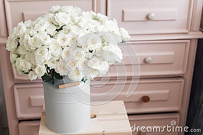 Vintage interior decoration pink pastel closet white roses in metal bucket. Stock Photo