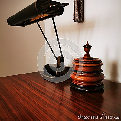 Antique table lamp and tobacco jar on the table. Stock Photo