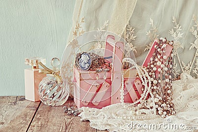 Vintage jewelelry, antique wooden jewelry box and perfume bottle on wooden table. filtered image Stock Photo