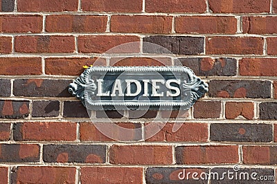 Vintage Ladies Sign on brick wall Stock Photo