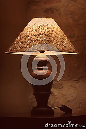 A vintage lamp beside a bed Stock Photo