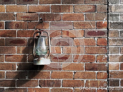 A vintage lamp hangs on old brick wall Stock Photo
