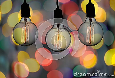 Vintage lamp or Modern Light bulb hang on ceiling in bokeh background. Stock Photo