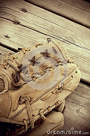 Vintage Looking Sepia Antique Baseball Glove on Wood Stock Photo