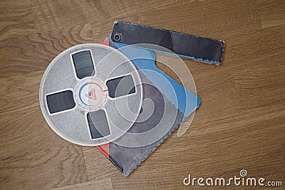 Vintage magnetic audio reel on the grunge wooden floor Stock Photo