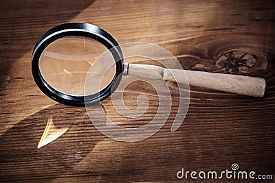 Vintage magnifer glass on old wooden board Stock Photo