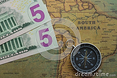 Vintage map of South America with five dolor bills and a compass, close-up Stock Photo