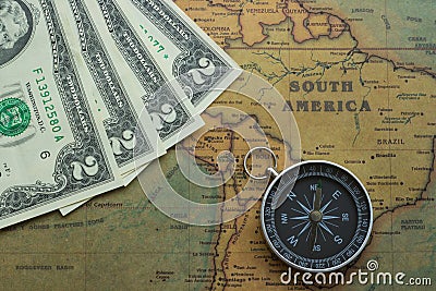 Vintage map of South America with two dolor bills and a compass, close-up Stock Photo