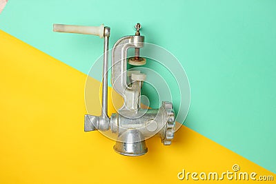 Vintage meat grinder on a pastel background, top view, minimalism. Stock Photo