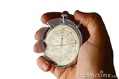 Vintage mechanical wind up stop watch held in left hand with fingers on reset positions, white background Stock Photo