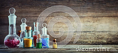 Vintage medications in small bottles on wood desk. Old medical Stock Photo