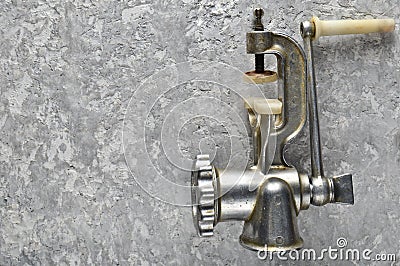 Vintage metal mincer on a gray concrete background. Top View. Stock Photo