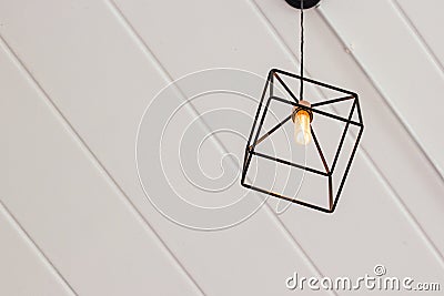 Vintage metal square lamp hanging on ceiling. Stock Photo