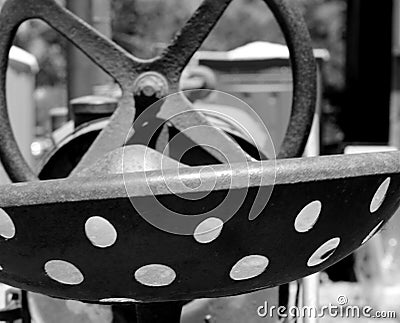 Vintage Metal Tractor Seat and Steering Wheel Stock Photo