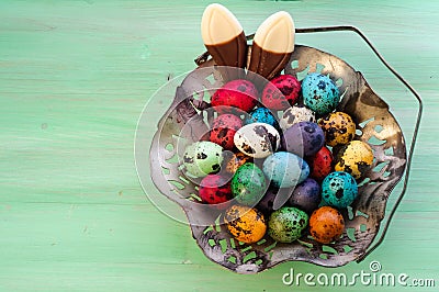 Vintage Metall Easter Eggs Basket and Chocolade Bunny Ears Stock Photo