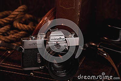 Vintage Minolta SR-T 101 film camera on an old suitcase Editorial Stock Photo