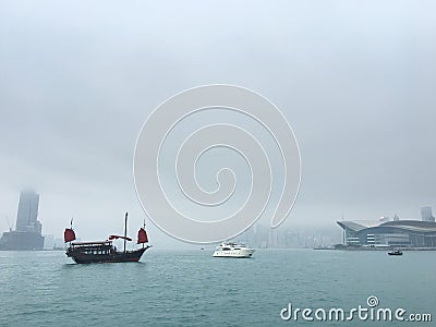 Vintage and modern boats in Victoria Harbour, Hong Kong Stock Photo