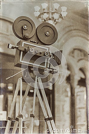 Vintage movie camera on a tripod, model. Processed with retro style. Cinema concept and other antiquities. For Stock Photo