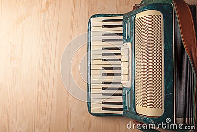 Vintage musical instrument accordion on wooden table Stock Photo