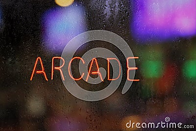 Vintage Neon Arcade Sign in Wet Rainy Window Stock Photo