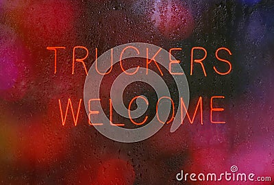 Vintage Neon Sign in Rainy Window Truckers Welcome Stock Photo