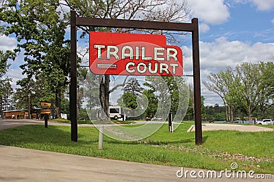 Vintage Neon Trailer Court Sign at RV Park Near Lake Editorial Stock Photo