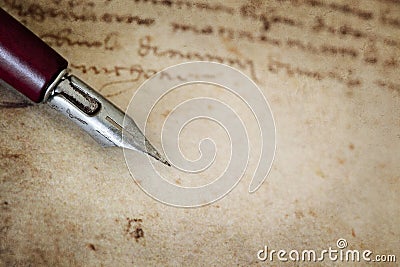 Vintage Nib Pen over Grunge Text Stock Photo